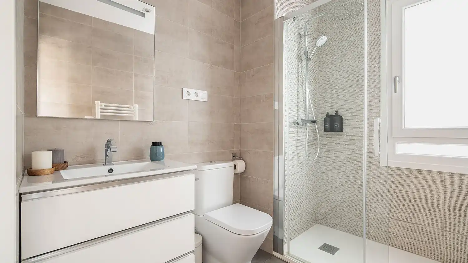 Walk-in shower fully clad in dramatic gray and white marble slab tiles in Justice