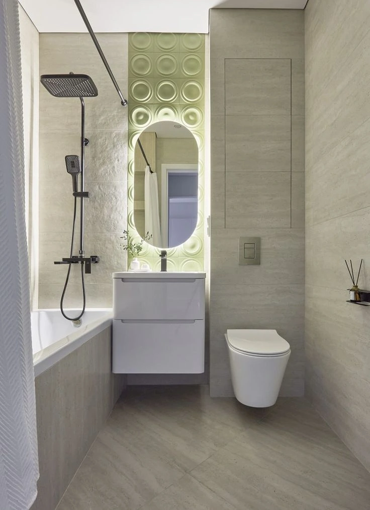 Modern bathroom with gray large-format wall tiles, oval LED mirror, and rain shower